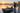 Small fishing boat at a dock while an operator checks a wireless motor remote